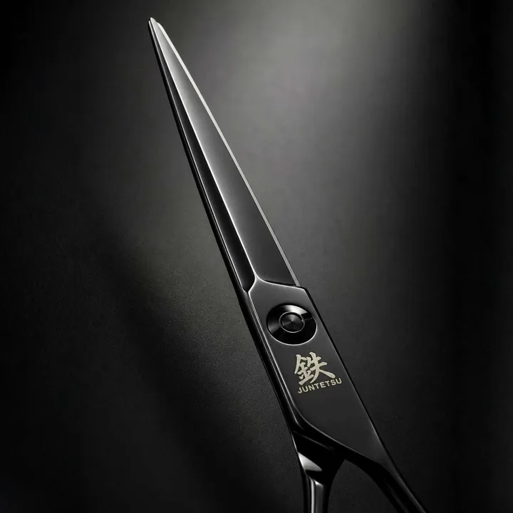 Close-up of a matte black Juntetsu cutting scissor blade on a black background